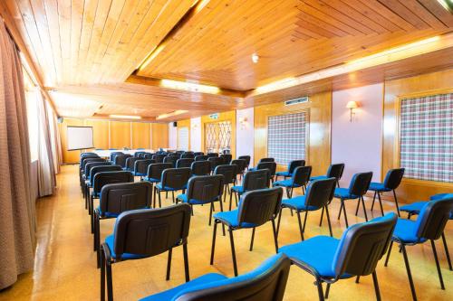 a large room with chairs and a podium in it at Hotel da Aldeia - Adults Only in Albufeira