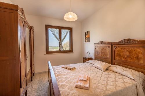 Un pat sau paturi într-o cameră la Podere Valle dei Venti
