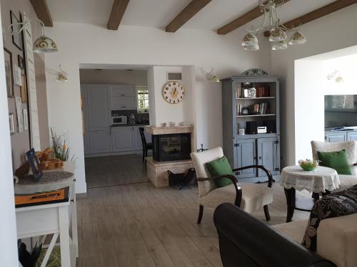 a living room with a couch and a fireplace at Edit Villa in Matrafured