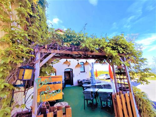 a restaurant with a pergola with a table and chairs at Gabrielle hôtel in Aiguines