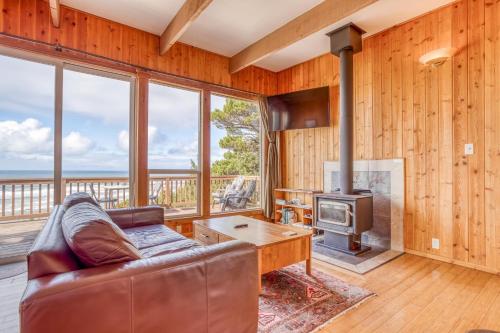 a living room with a couch and a fireplace at Shorepine Retreat in Newport
