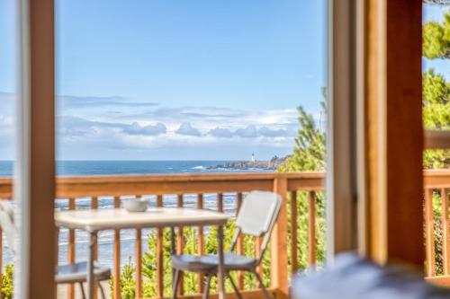 a balcony with a table and chairs and the ocean at Shorepine Retreat in Newport