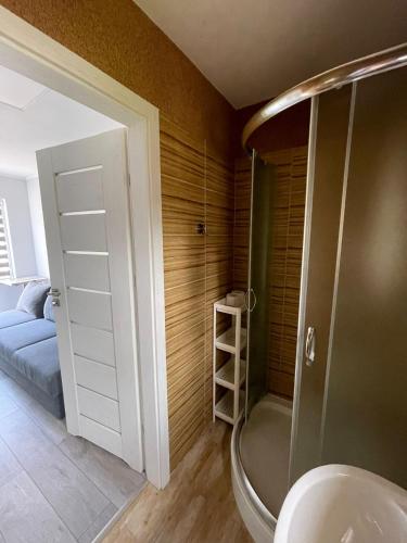 a bathroom with a shower and a sink in a room at Willa Atlantis in Mielno