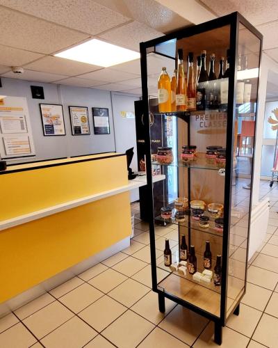 a display case in a store with wine bottles at Premiere Classe Honfleur in Honfleur