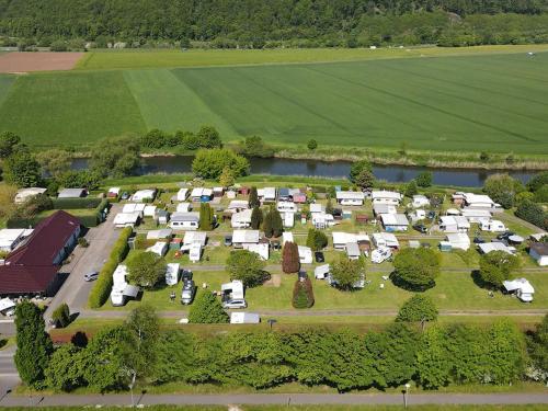an aerial view of a farm with a bunch of trailers at Camping Oase Wahlhausen in Wahlhausen