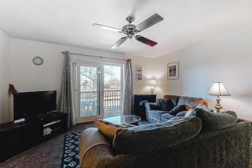 a living room with a couch and a ceiling fan at Raffles in Ocean City