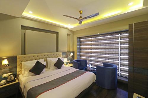 a bedroom with a large bed and a window at The IVY Grand Hotel - 5 Minutes from Connaught Place and New Delhi Railway Station With Free Secured Parking in New Delhi