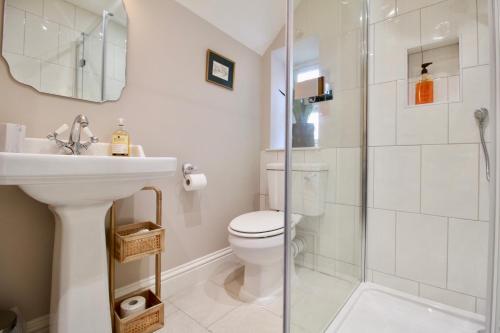 a bathroom with a toilet and a sink and a shower at 14th century Rose cottage, Centre of Alfriston By Air Premier in Alfriston