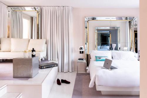a bedroom with a bed with a laptop on it at Hotel Palazzina Grassi in Venice