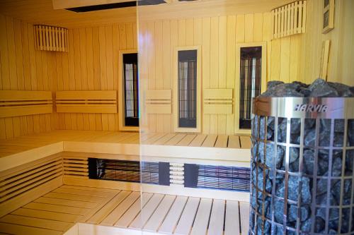 a room with a wooden floor and a column of rocks at Ferrata Vendégház in Csesznek