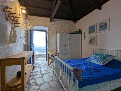 a bedroom with a bed and a refrigerator at Blue Horizon in Hydra