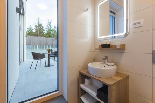 a bathroom with a sink and a view of a patio at Vila Rina in Bled