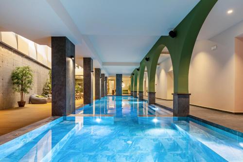 a swimming pool in the middle of a building at Minos Ambassador Suites & Spa - Adults only in Rethymno
