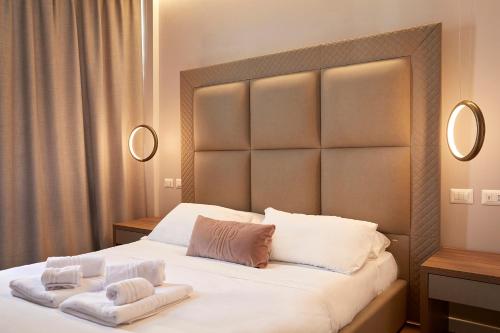 a bedroom with a large bed with two towels on it at PRESTIGE BOUTIQUE APARTHOTEL -Piazza Duomo in Milan