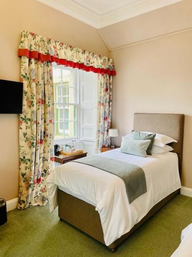 a bedroom with a large bed and a window at West Plean House in Stirling