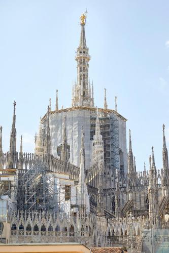 a building being constructed in front of a cathedral at PRESTIGE BOUTIQUE APARTHOTEL -Piazza Duomo in Milan