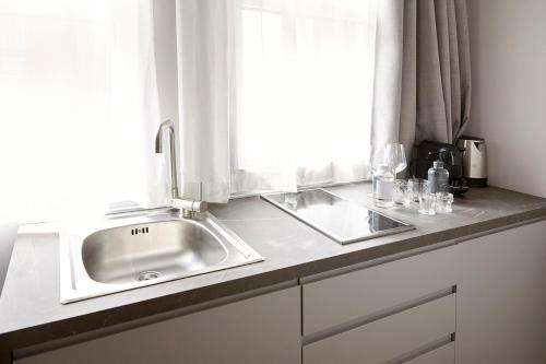 a kitchen counter with a sink and a window at PRESTIGE BOUTIQUE APARTHOTEL -Piazza Duomo in Milan