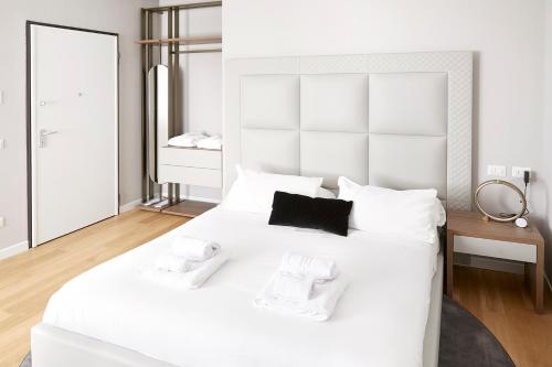 a white bedroom with a large white bed with white pillows at PRESTIGE BOUTIQUE APARTHOTEL -Piazza Duomo in Milan