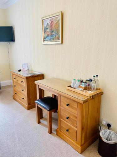 a room with a wooden desk and a chair at West Plean House in Stirling