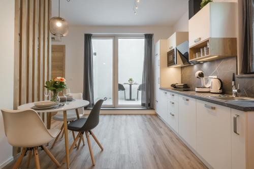 a kitchen with a table and chairs and a dining room at Vila Rina in Bled