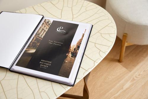 a book sitting on top of a table at PRESTIGE BOUTIQUE APARTHOTEL -Piazza Duomo in Milan