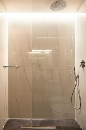 a shower with a glass door in a bathroom at PRESTIGE BOUTIQUE APARTHOTEL -Piazza Duomo in Milan
