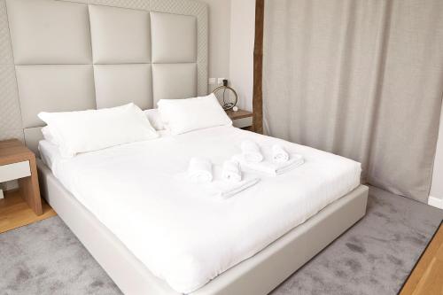 a white bed with two white towels on it at PRESTIGE BOUTIQUE APARTHOTEL -Piazza Duomo in Milan