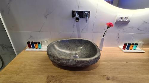 a bathroom with a large stone sink on a counter at St-Georges IV in Ieper