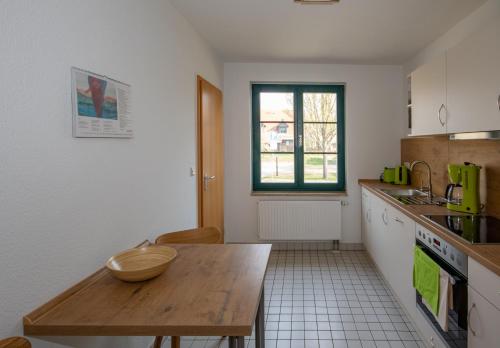 a kitchen with a wooden table with a bowl on it at Spreewälder Feriendomizil/Pension in Burg