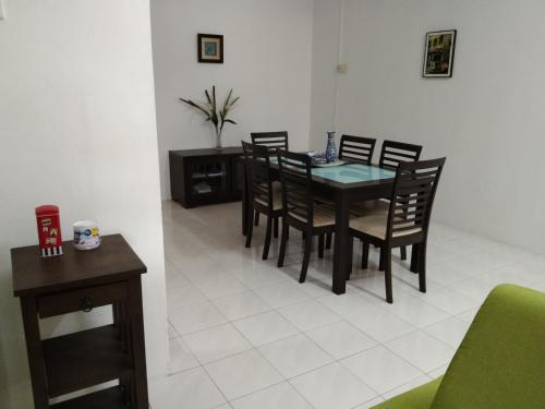 a dining room with a table and chairs at Afamily Homestay in Ipoh