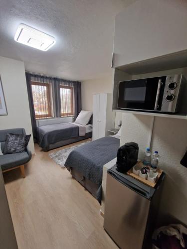 a small room with a bed and a couch at Unique Messe - Airport in Steinenbronn