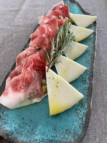a plate with meats and cheese on a table at Turia Valencia in Valencia