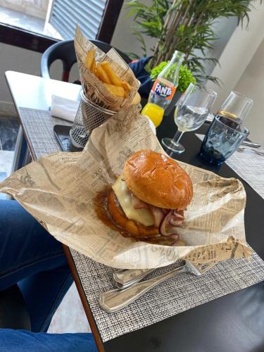 a sandwich and french fries on a table at Turia Valencia in Valencia