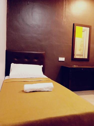 a bed with two towels on top of it at D LAYARAN KUANTAN LPT Exit 833 in Kuantan