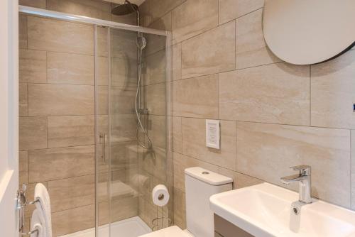 a bathroom with a shower and a toilet and a sink at 4 Berkeley Square I Your Apartment in Bristol