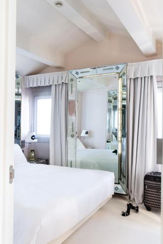 a bedroom with a bed and a mirror at Hotel Palazzina Grassi in Venice