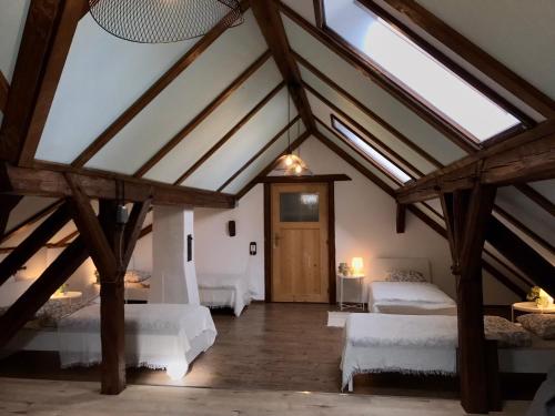 a attic room with two beds and a wooden door at Jutta Deluxe Farmhouse in Zwettl Stadt