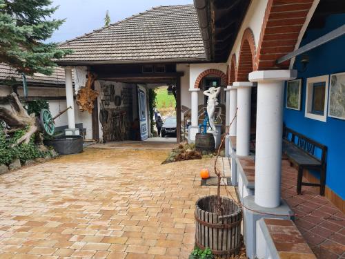 a house with a brick driveway and a blue wall at Jutta Deluxe Farmhouse in Zwettl Stadt