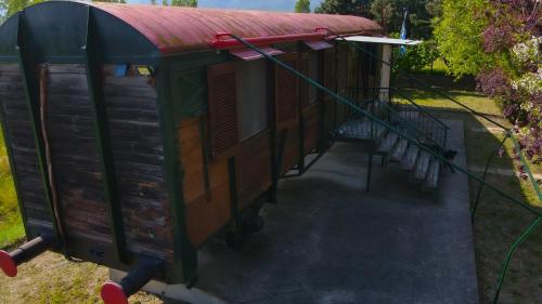 a train house with a red roof on a platform at Train in the Forest in Aridaia