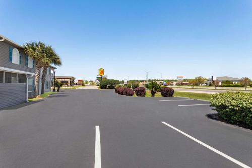 an empty parking lot in front of a building at Super 8 by Wyndham Foley in Foley