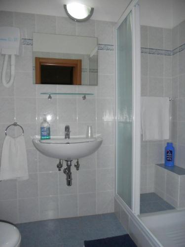a white bathroom with a sink and a shower at Hotel San Lorenzo in Florence