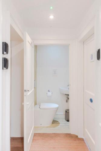 a bathroom with a white tub and a toilet at 4 Berkeley Square I Your Apartment in Bristol