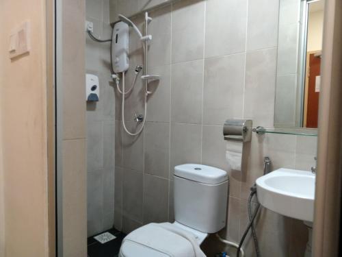 a bathroom with a toilet and a sink at AVENUE BANGI HOTEL in Kajang