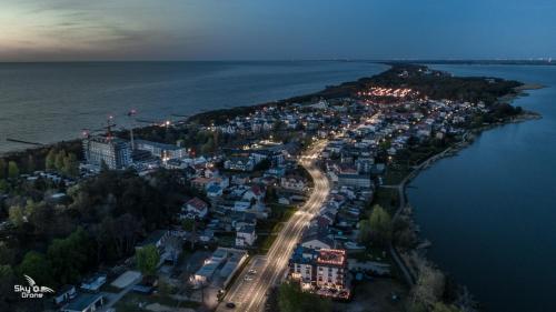 an aerial view of a town on an island in the water at Hotel Emocja SPA in Mielno