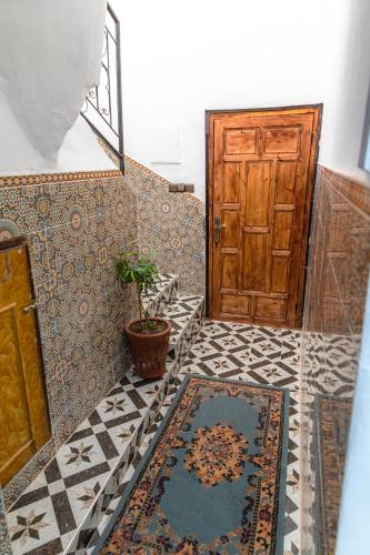 a hallway with a door and a rug on the floor at Amazigh Family Riad in Imlil