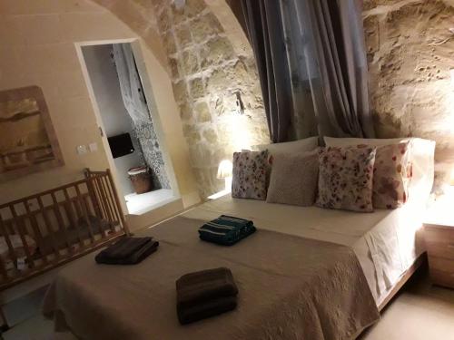 een slaapkamer met een bed met twee handdoeken erop bij Taz-Zubi Farmhouse in San Katald