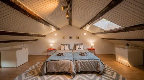a bedroom with a large bed in a attic at Casa Emiliana in Raša