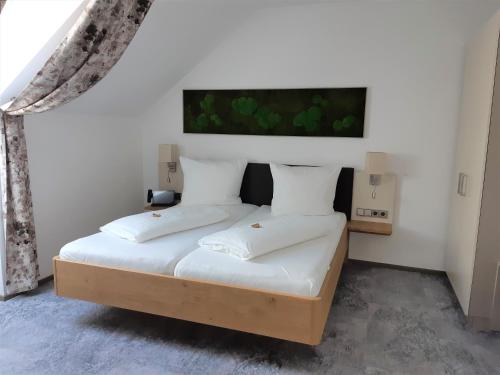 a bedroom with a bed with two white pillows at Hotel Kongress in Leoben