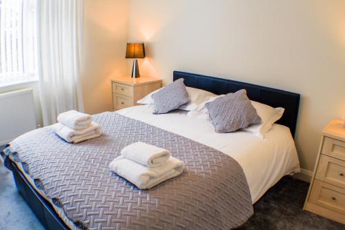 a bedroom with a bed with towels on it at 18 Sea View Close in Scarborough