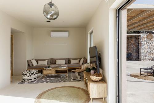 a living room with a couch and a table at Aristotelis Residence in Petres